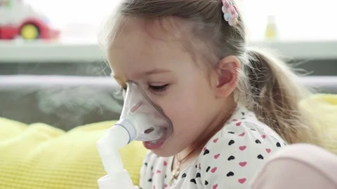 Close up Caucasian 3-4 years minor preschool girl kid in the mask of an inhaler Stock Footage 149079906