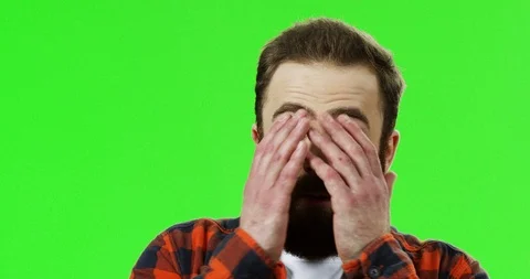 Close up of the Caucasian disturbed man with a beard worrying and holding his Stock Footage 90362822