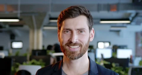 Close up of Caucasian handsome man looking at camera and smiling in office Stock Footage 180051951