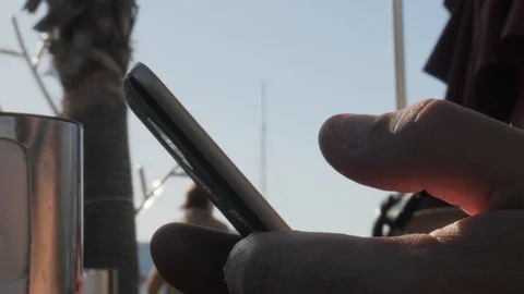 Close up on Caucasian male hand using his cellphone outdoor. Stock Footage 122045899