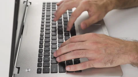 Close up, caucasian man is typing, using keyboard on laptop with his hand  Stock Footage 138042128