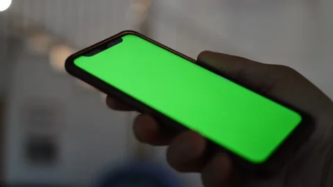 Close-up caucasian man using iphone with green screen display. Video stock 206042431
