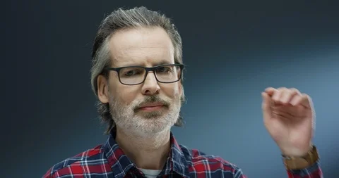 Close up of Caucasian midde-aged handsome man in motley shirt and with gray Stock Footage 125465283