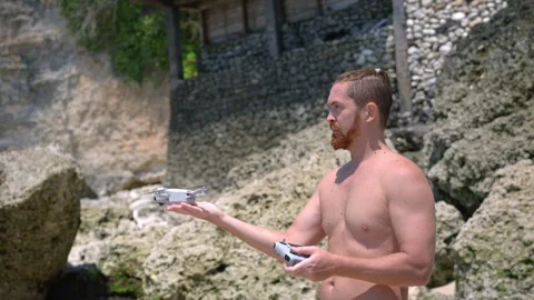 Close up caucasian white man with red beard control by drone on the beach. Stock Footage 292099665