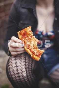 Close Up Of Caucasian Woman Eating Pizza Outdoors