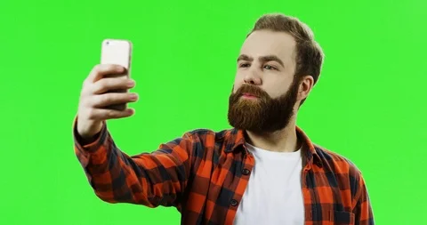 Close up of the caucasian young man with a beard and in the motley shirt taking Stock-Footage 90379694
