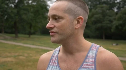 Close-up of Caucasian young man talking in public park in slow motion Stock-Footage 114874226