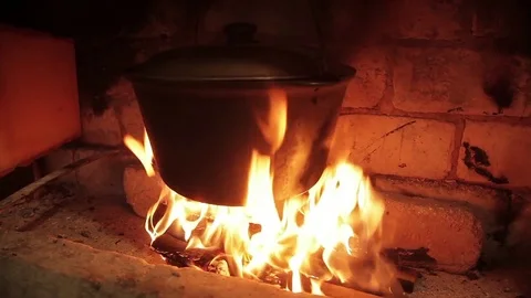 Close-up cauldron of soup hanging over a burning fire Stock-Footage 71943968