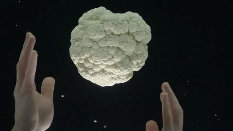 Close-up of cauliflower falling into the water against a black background. Stock Footage 273068529