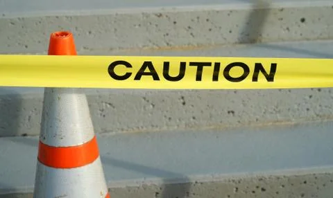 Close up on caution on yellow stripe Stock Photos