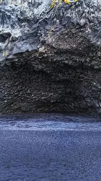Close-up of a cave ceiling with rocks and blue water below Stock Photos