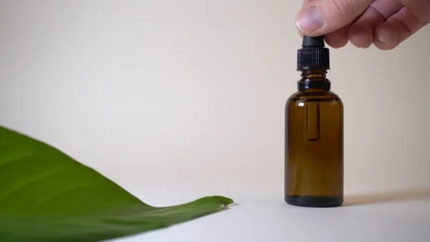 Close up of CBD or any other essential oil dripping into a medine bottle - wh Stock Footage 122693084
