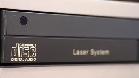 Close-up of CD tray on vintage player extending and retracting Stock Footage 89921868