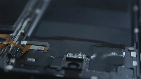 Close-up of a cell phone repair. The internal components of a smartphone. Dis 動画素材 113398306