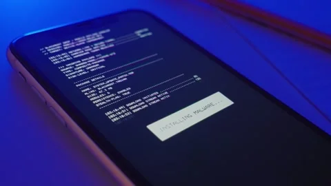 Close up on cellphone malware installing app with code for hacking into device Vidéo 323842219