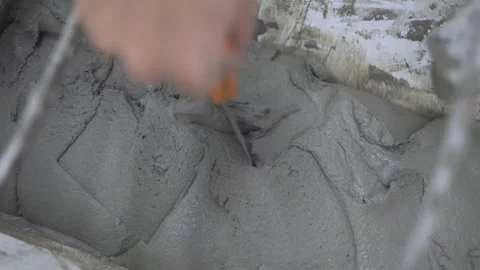 Close up Cement mixing in machine and crew is checking 50fps Stock-Footage 243975583