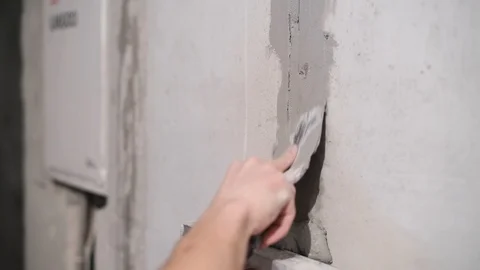 Close-up of cement mortar getting on unevenness in the wall. Stock Footage 126914118