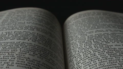 Close-up centered flyby of open Bible Stock Footage 146936992