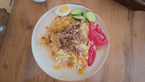 Close-up of Central Asian plov rice dish in a restaurant, Kyrgyzstan Stockbeeldmateriaal 347242535