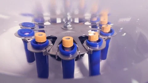 Close up of centrifugation of assays in test tubes Video stock 77363394