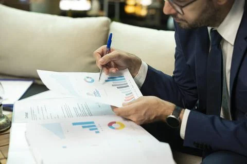 Close up of CEO analyzing earnings report data on papers Stock Photos