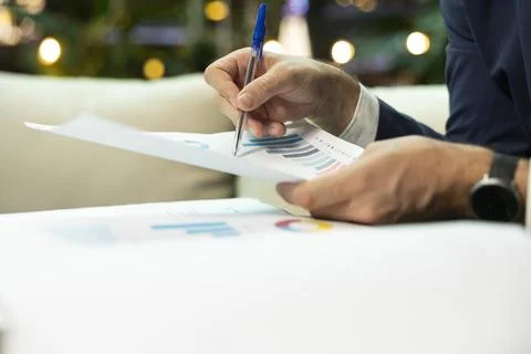 Close up of CEO checking business report charts with pen for evaluation Stock Photos