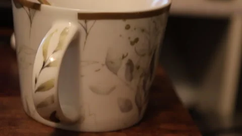Close-up of Ceramic Coffee Mug with Floral Leaf Patterns Stock Footage 328728239