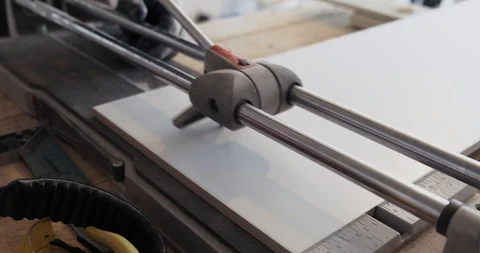 Close-up of ceramic tile cutting machine, male builder cuts ceramics, halves Stock Footage 129839980