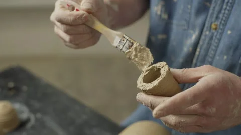 Close-up of a ceramist preparing a small part for a sculpture. Stock Footage 250021512