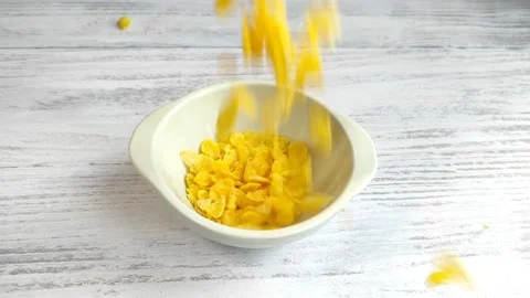Close up of cereal being dropped into a breakfast bowl Stock Footage 237516644