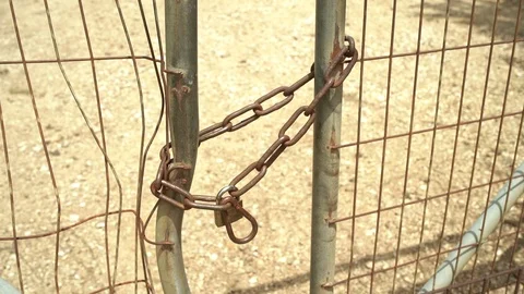 Close up of a chain and a lock of a metal gate in rural area Stock Footage 107544609