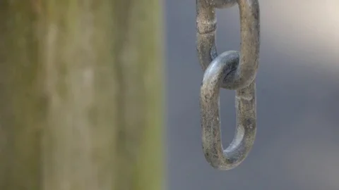 Close-Up of Chain Hanging from Wooden Post, 4K Stock Footage 72879206