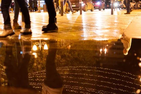 Close up of Chain of Lights reflected on Water on the Street in Holiday perio Stock Photos