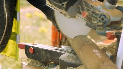 Close-up of chainsaw cutting a log outdoors Stock Photos