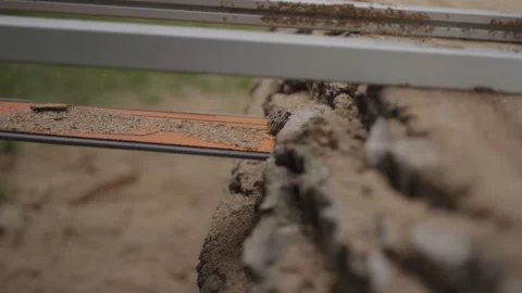 Close-Up of Chainsaw Cutting Through Wood Stock Footage 333353624