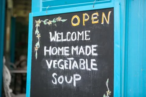 Close-up chalk board with an invitation to vegetable soup, selective focus Stock Photos