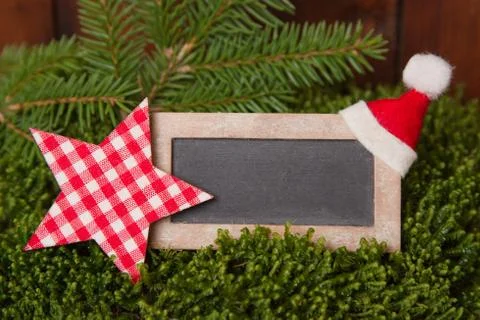 Close up of chalkboard with checked star and santa hat Stock Photos