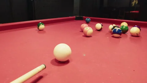 Close up of chalked cue and white ball on a red felt table Video stock 329192981