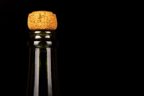 Close-up of champagne corks aligned on the left against a black background... Stock Photos