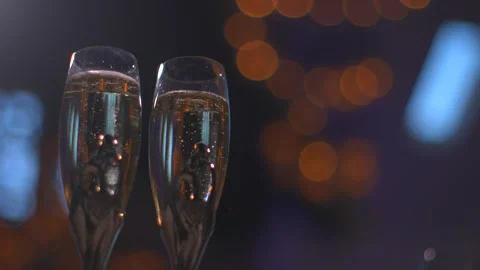 Close up of champagne glasses with bubbles and bokeh lights in the background 스톡 동영상 345260403