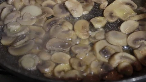Close-up, Champignon mushrooms when cooked in a pan. Slowly dolly shot Stock Footage 121330531