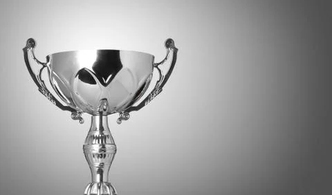 Close up champion silver trophy on grey background Stock Photos