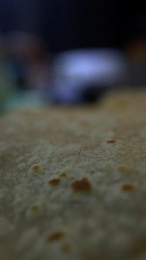 Close-up of chapati dough with blurred cook in background Stock Footage 343876733