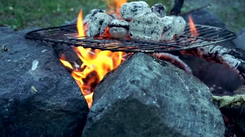 Close up of charcoal  on a campfire heating up for bbq Stock Footage 65133135