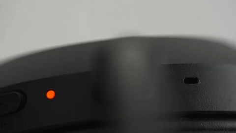 Close-Up of Charging Cable Plugging into Wireless Headphones Video stock 332082189