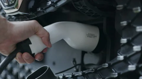 Close-up of charging hand to power the electric Car. Automotive technology Stock Footage 147336087