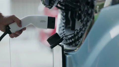 Close-up of charging hand to power the electric Car. Automotive technology Vídeo Stock 147336493