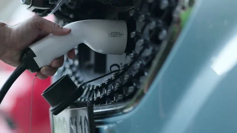 Close-up of charging hand to power the electric Car. Automotive technology Stock Footage 147336564