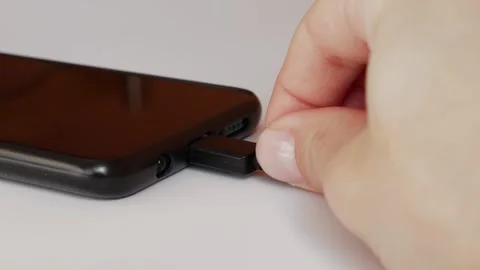 Close-up of charging a smartphone through a cable. Stock Footage 306180023