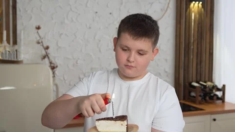 Close-up of charming caucasian little boy making wish and blowing candles on Stock Footage 262003992